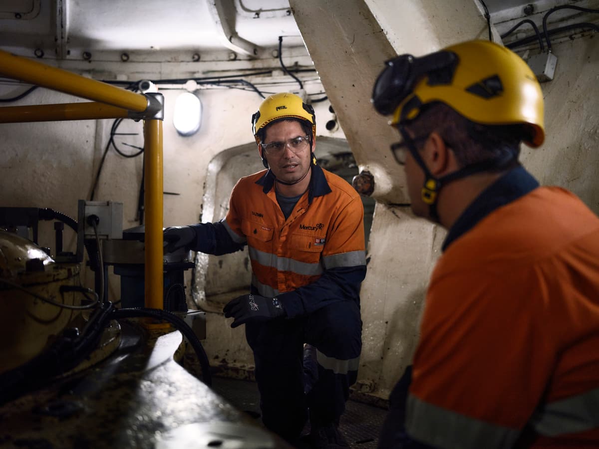 Two workers underground inspecting infrastructure