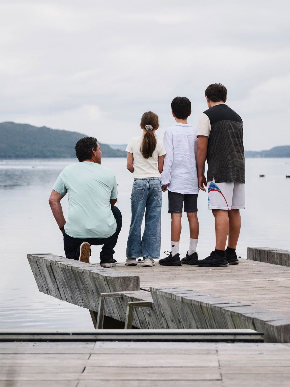 Family standing on a wharf