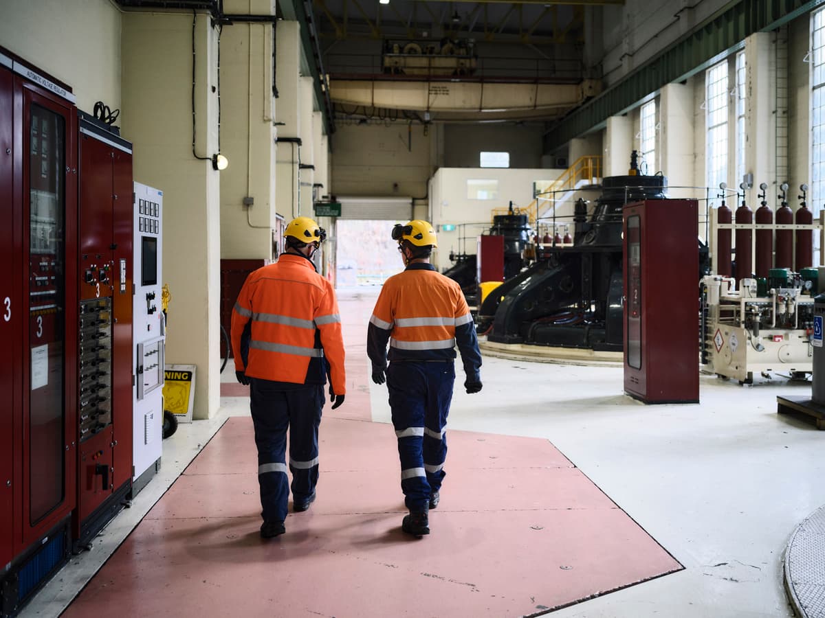Two workers in high-viz walking away