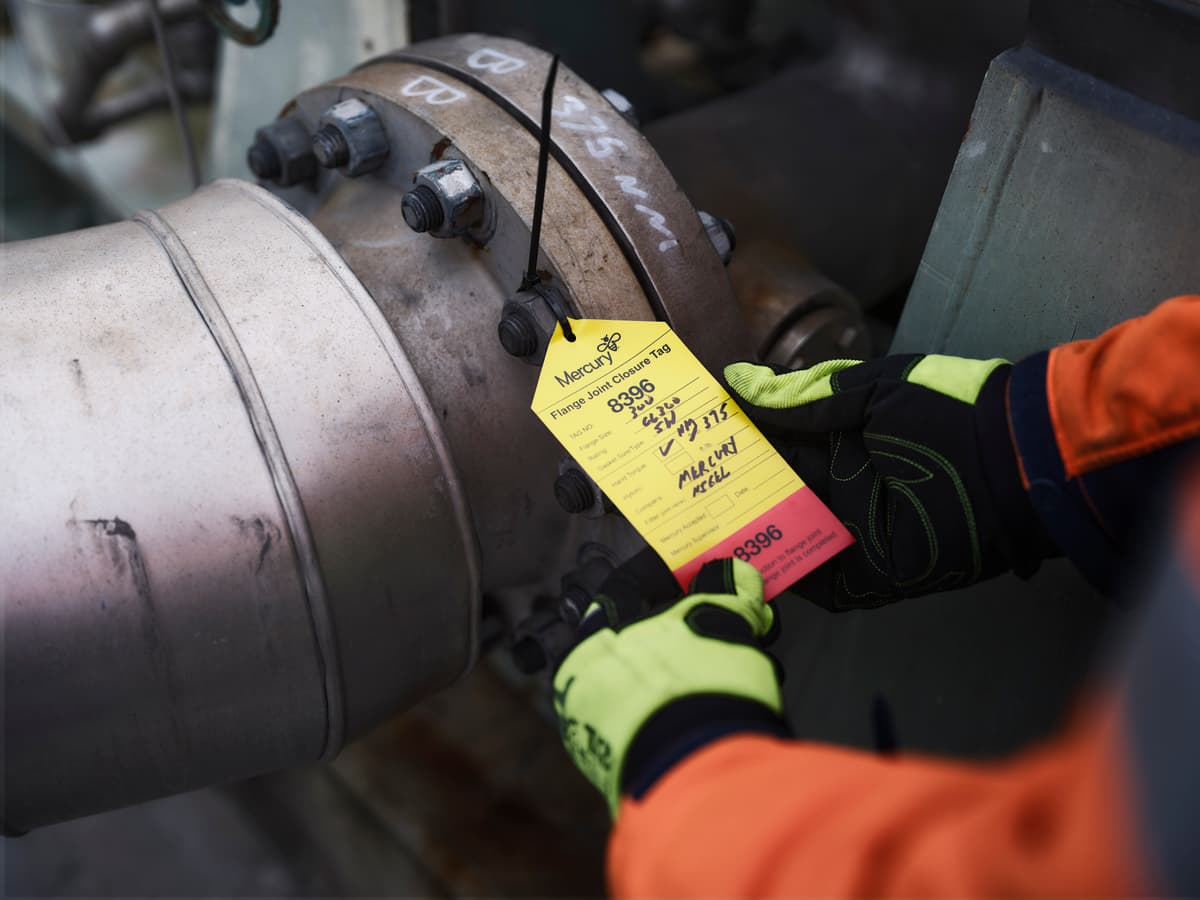 Hands holding yellow and red tag