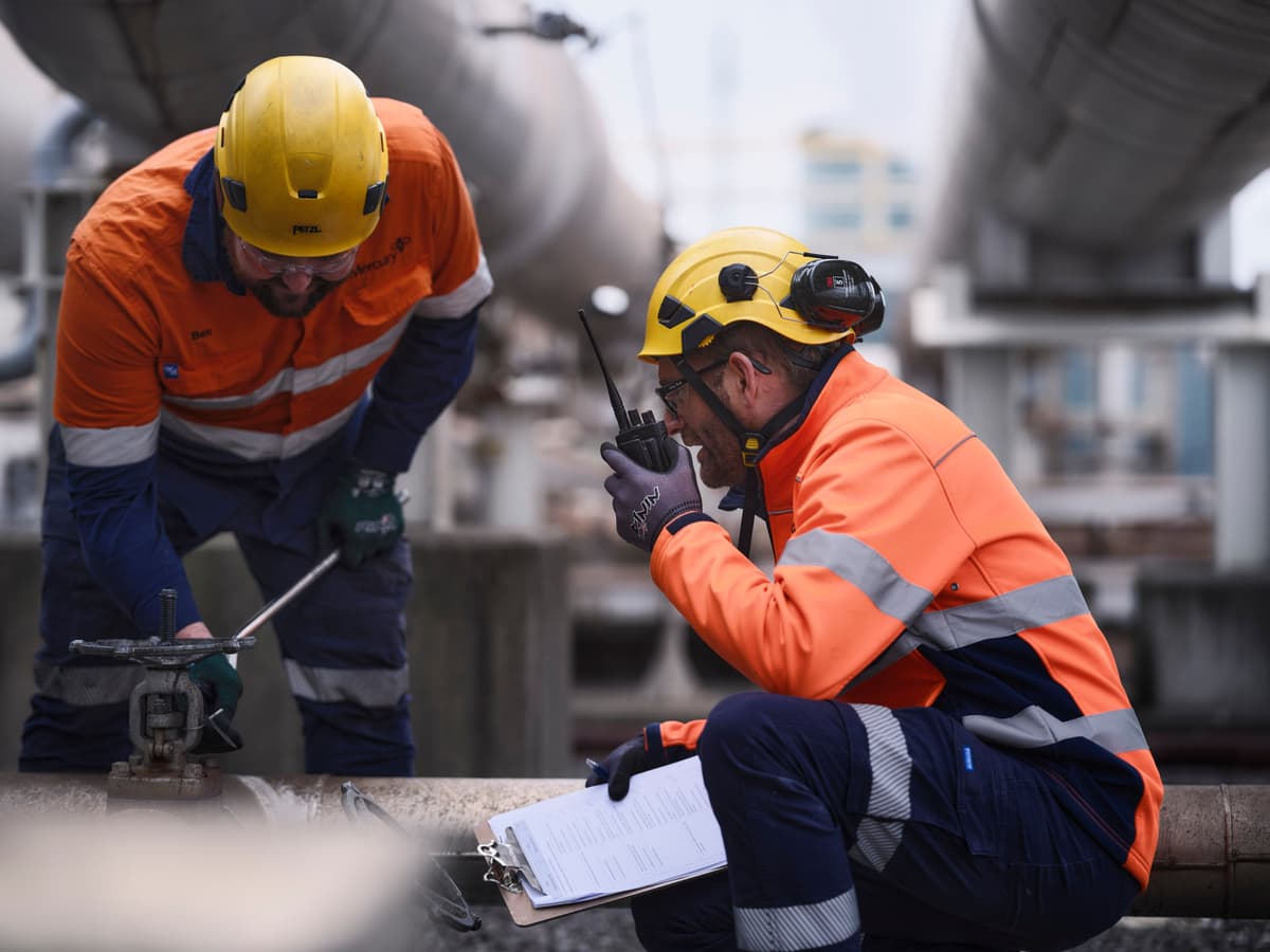 Two workers one on a radio